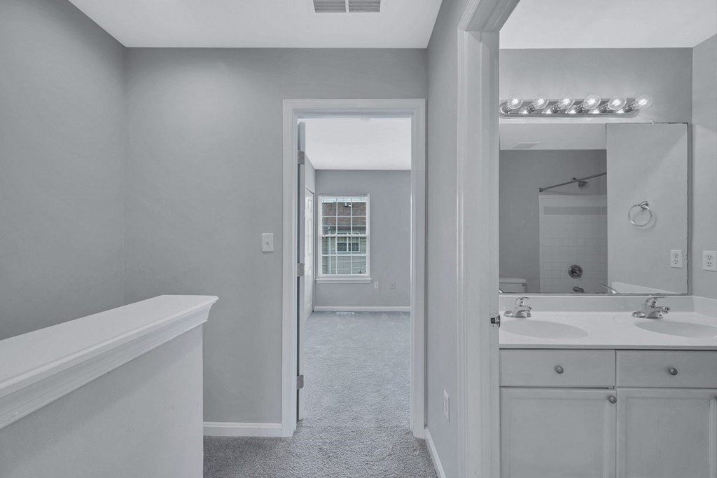 a white bathroom with a sink and a mirror
